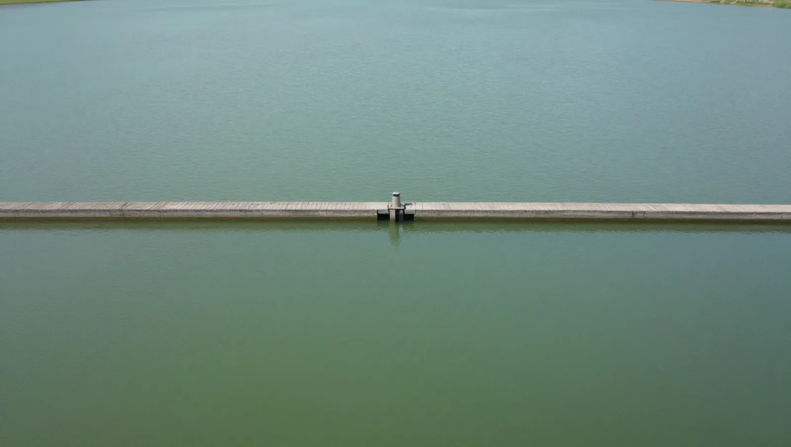 Sluice gates on a concrete weir control water flow between two water bodies — Daniel Dean Land Clearing, Southeast Texas