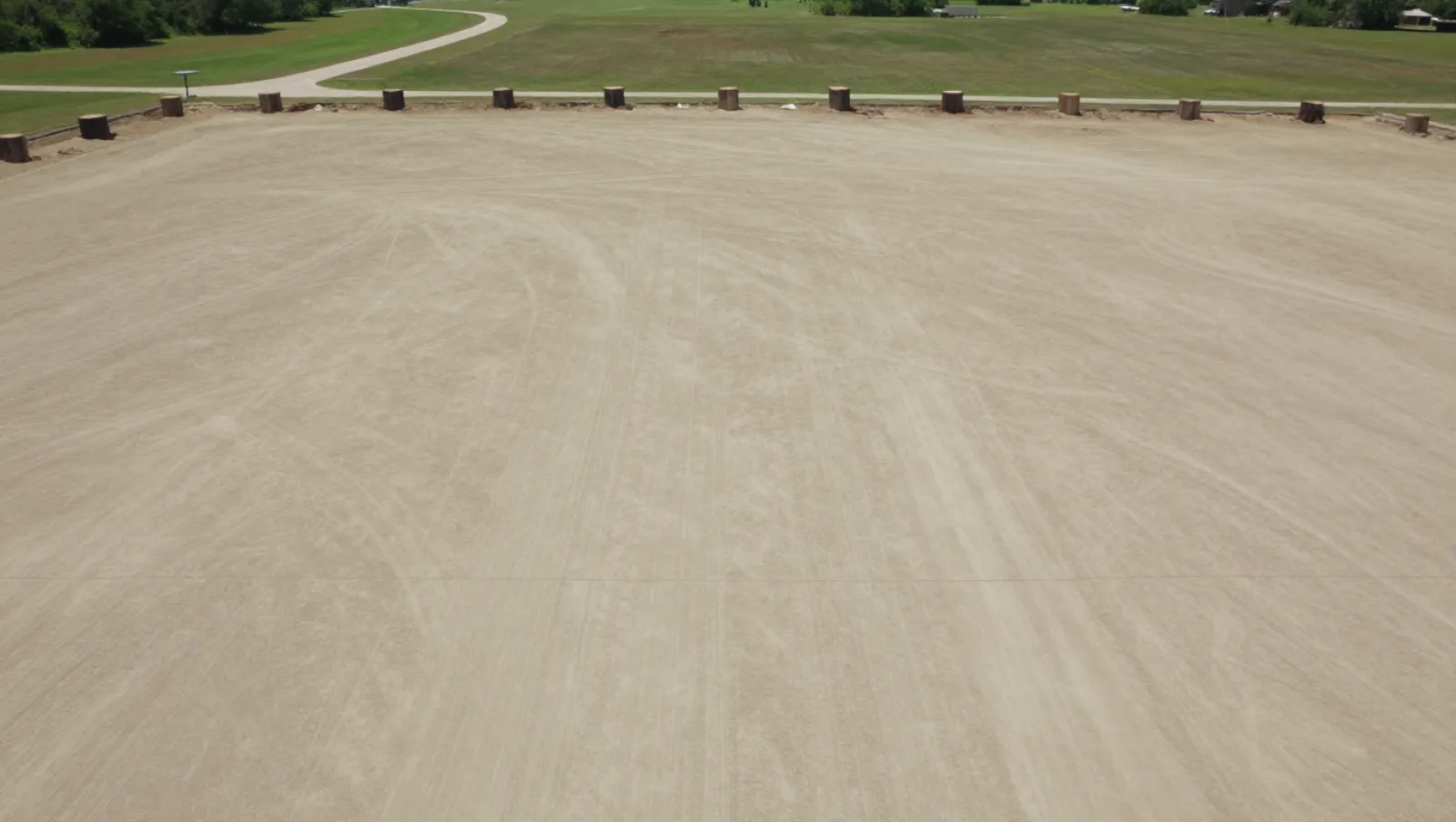 Heavy machinery graded dirt terrain for construction near grassy fields lined by wooden posts — Daniel Dean Land Clearing, Southeast Texas