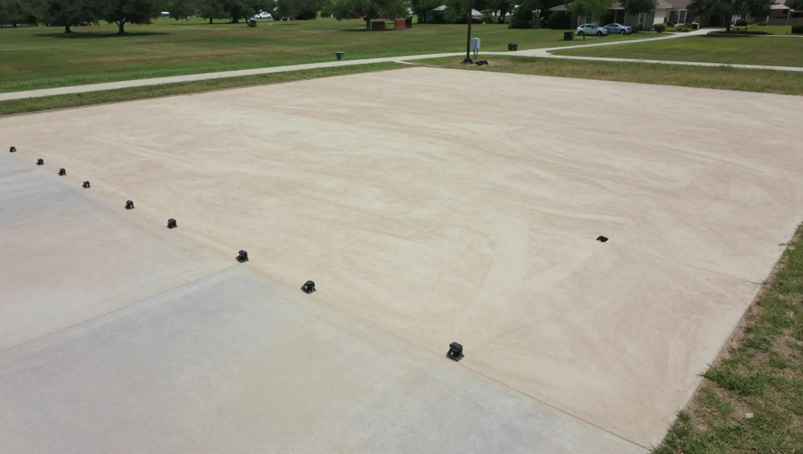 Excavation and site development in Houston, Texas — completed work Ground anchors rest on a large concrete surface during construction activity — excavation and site development in Houston, Texas