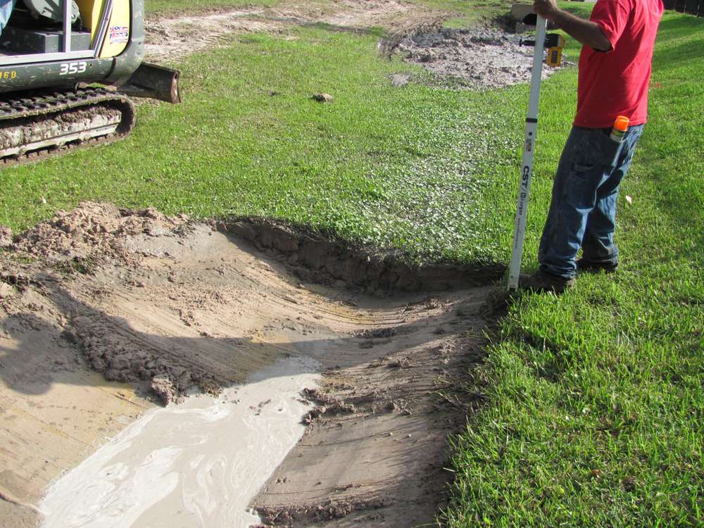 Ditch regrading project with excavation equipment