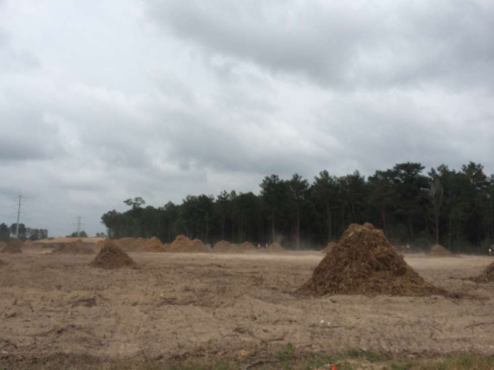 Commercial site preparation with grading equipment