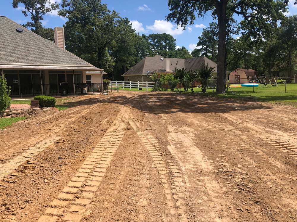 Swale redirecting water away from home