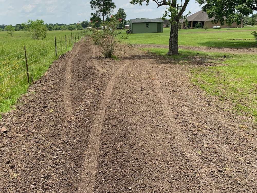 Berm construction redirecting water flow on property