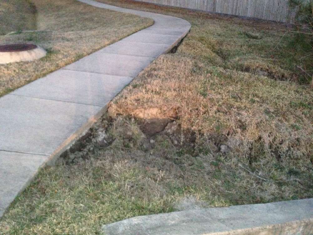 Sinkhole before repair showing soil collapse
