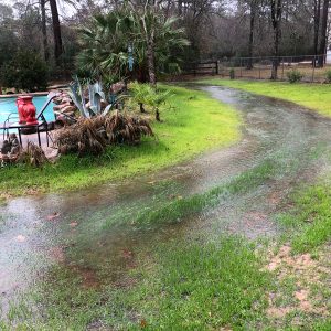 Swale redirecting water around the pool